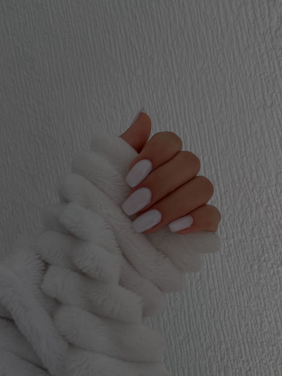 A woman with white nails holding her hands up - Nails