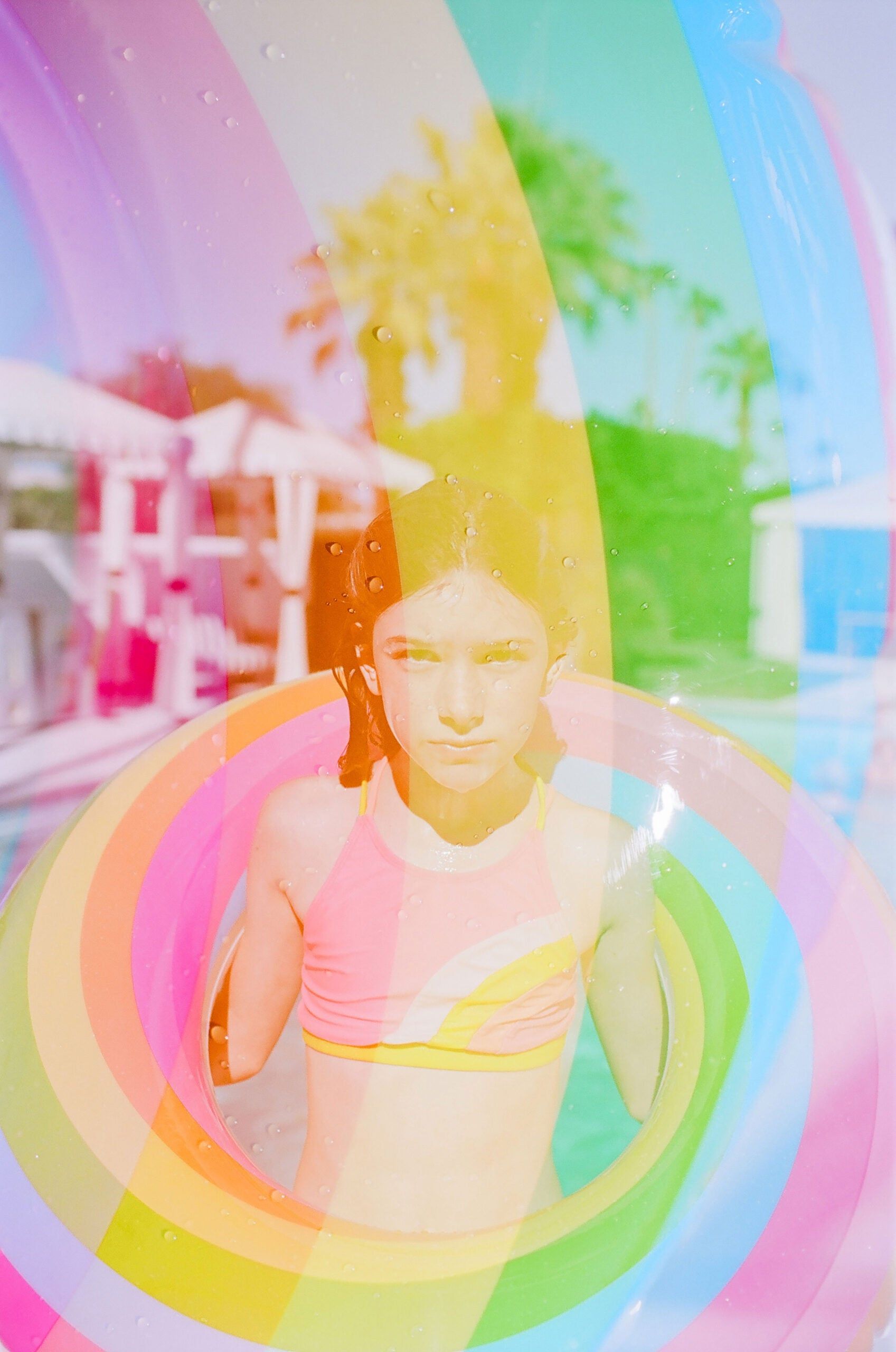 A girl in a bikini standing in a rainbow-colored swimming pool ring.  - Jennifer Lawrence