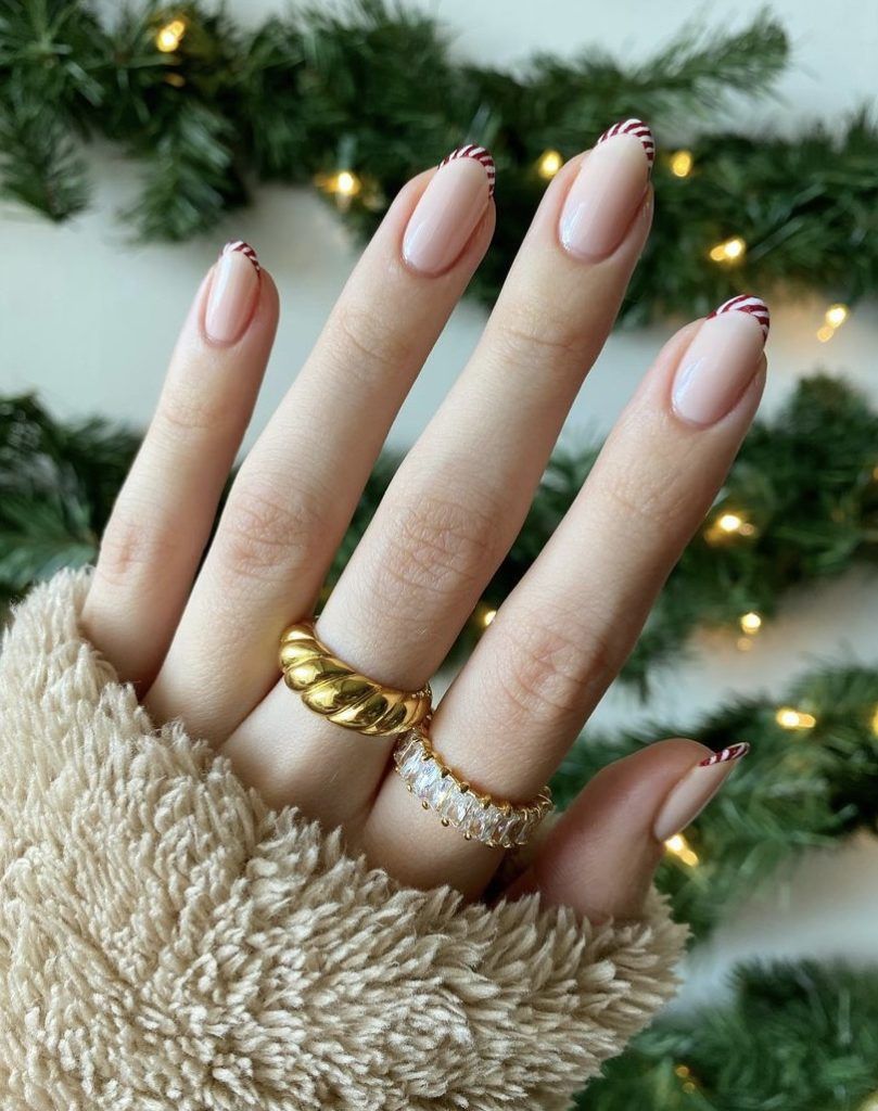 A woman's hand with white nails and gold rings - Nails