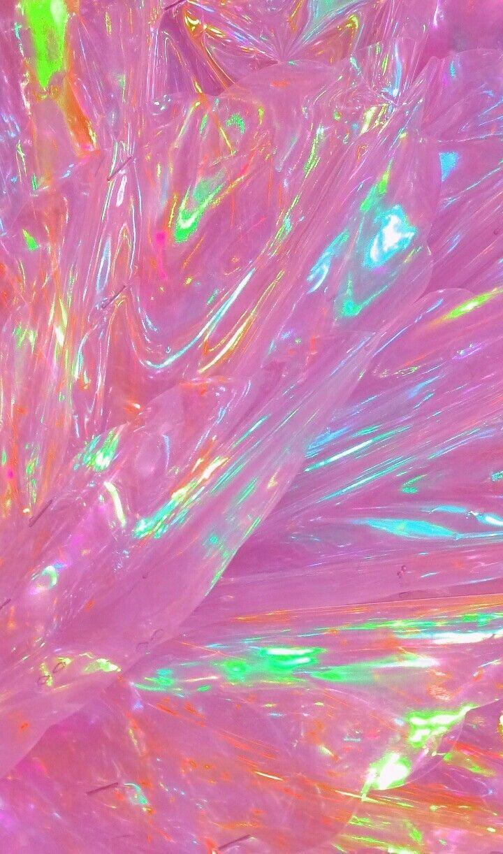 A pink holographic background with a rainbow of colours - Holographic