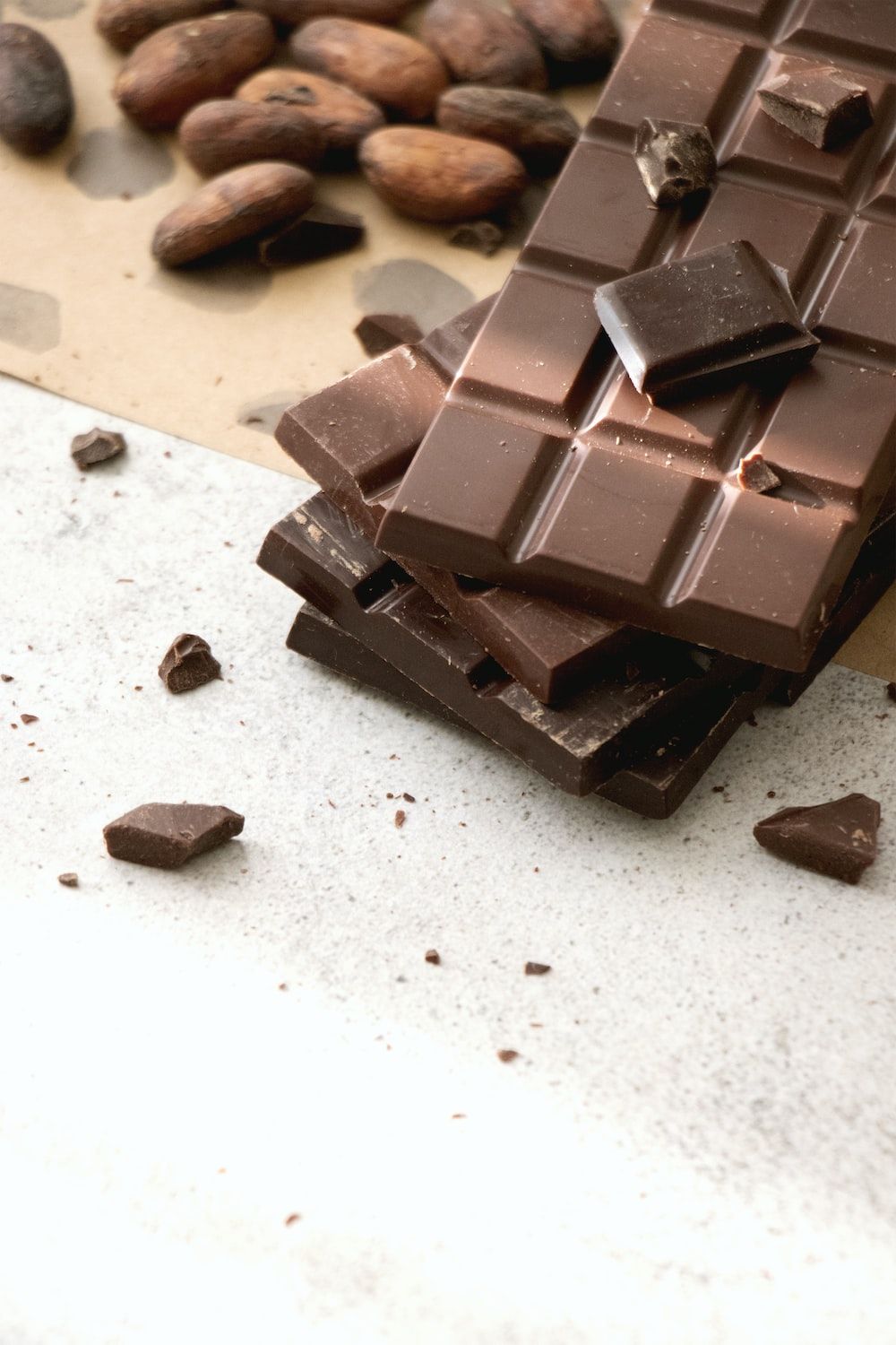 Dark chocolate bars with cocoa beans on a table - Chocolate