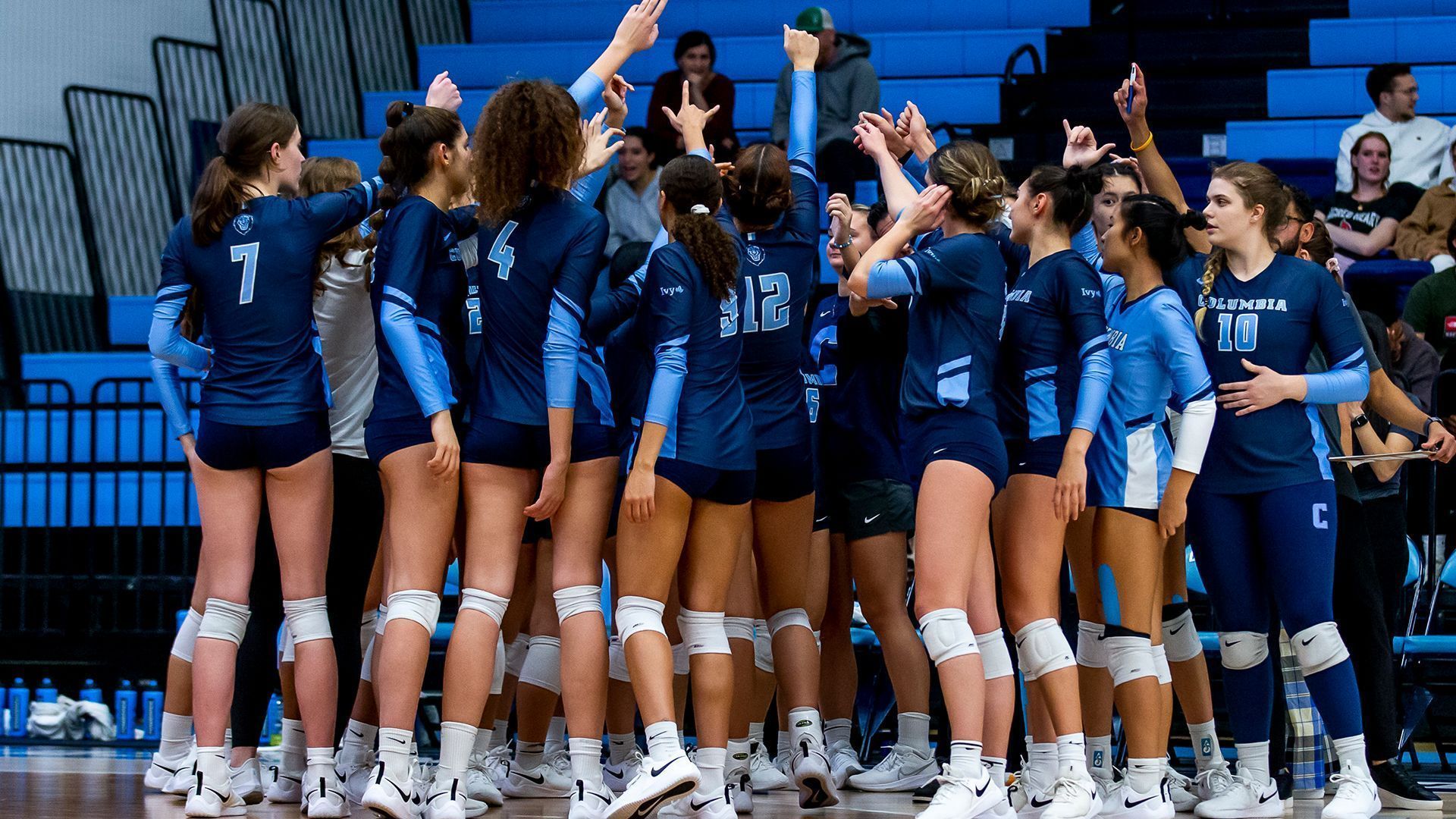 The volleyball team huddles together before a game. - Columbia University