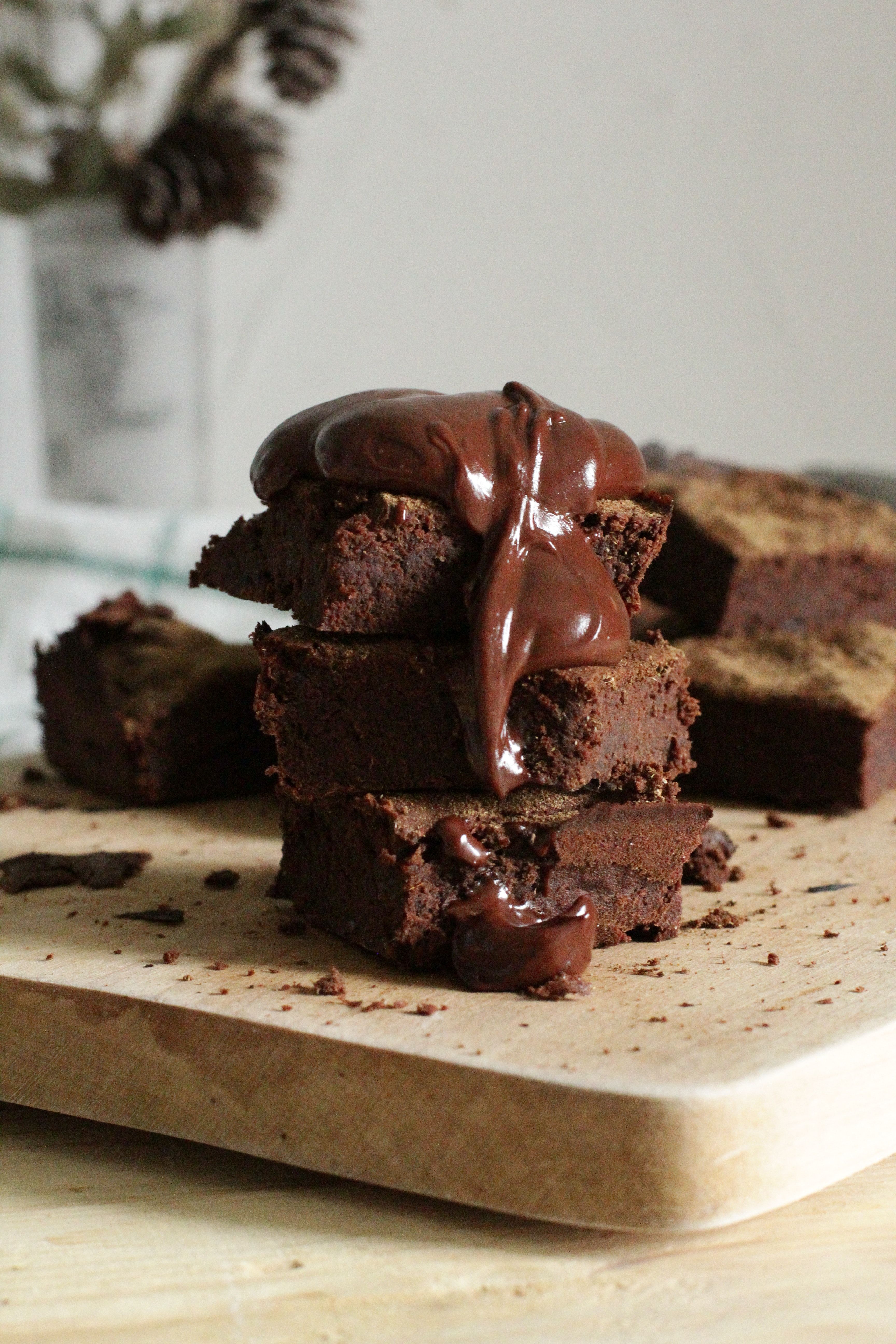 Four brownies stacked on top of each other with chocolate dripping down the sides. - Chocolate, bakery, cake
