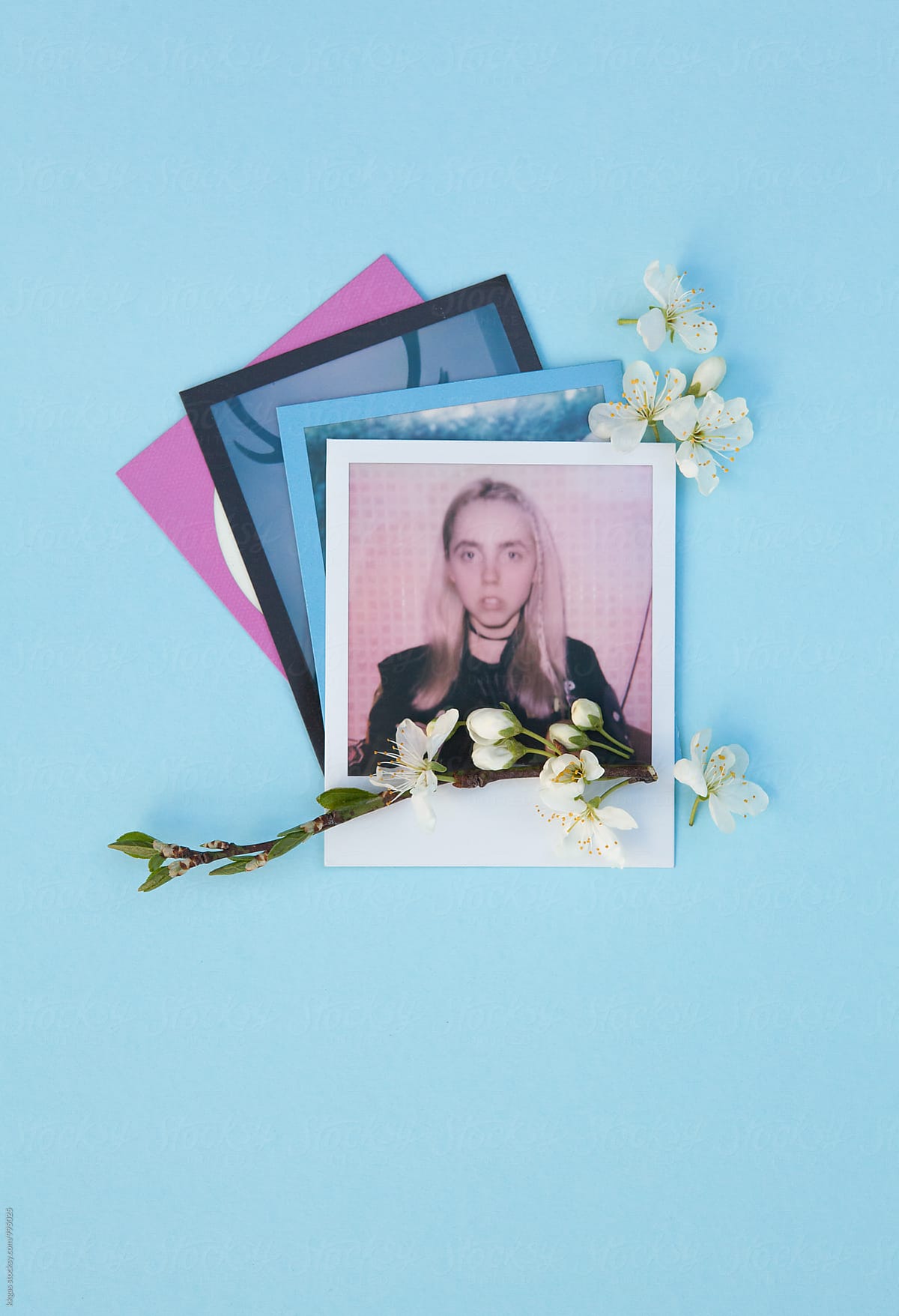Polaroid picture of a woman with cherry blossoms on a blue background - Polaroid