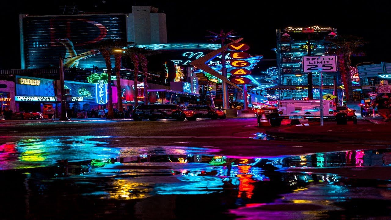 Las Vegas at night with neon lights reflecting in a puddle. - Las Vegas