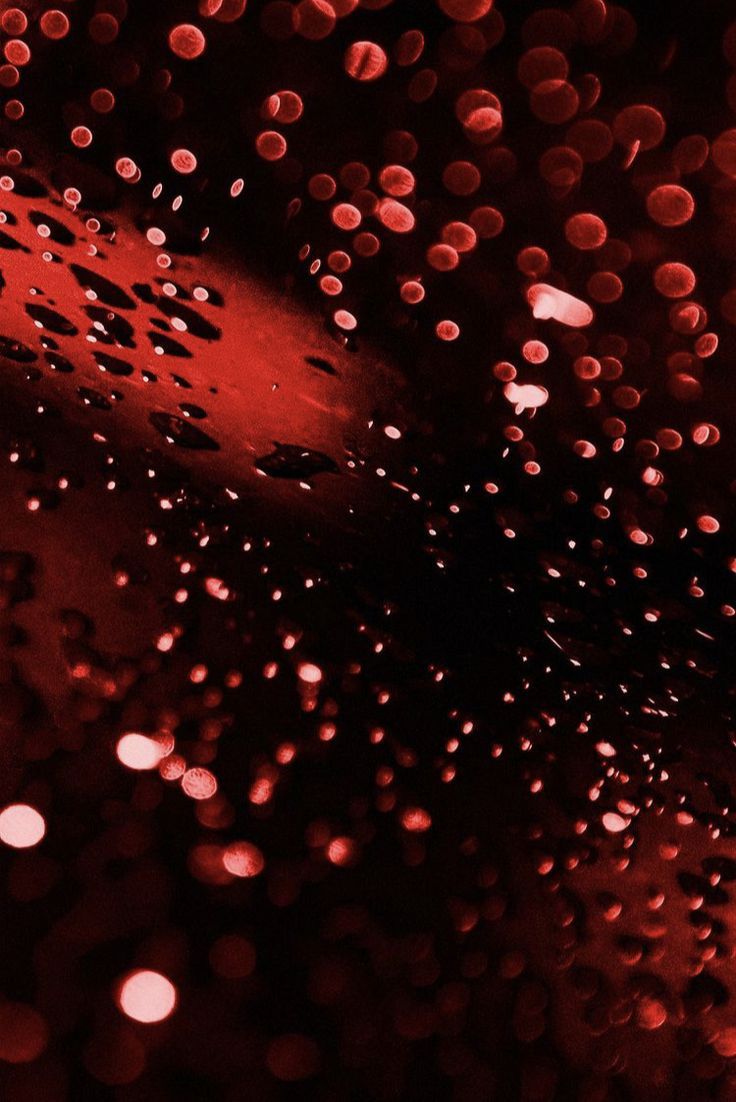 A close up of red bubbles on a black background - Crimson