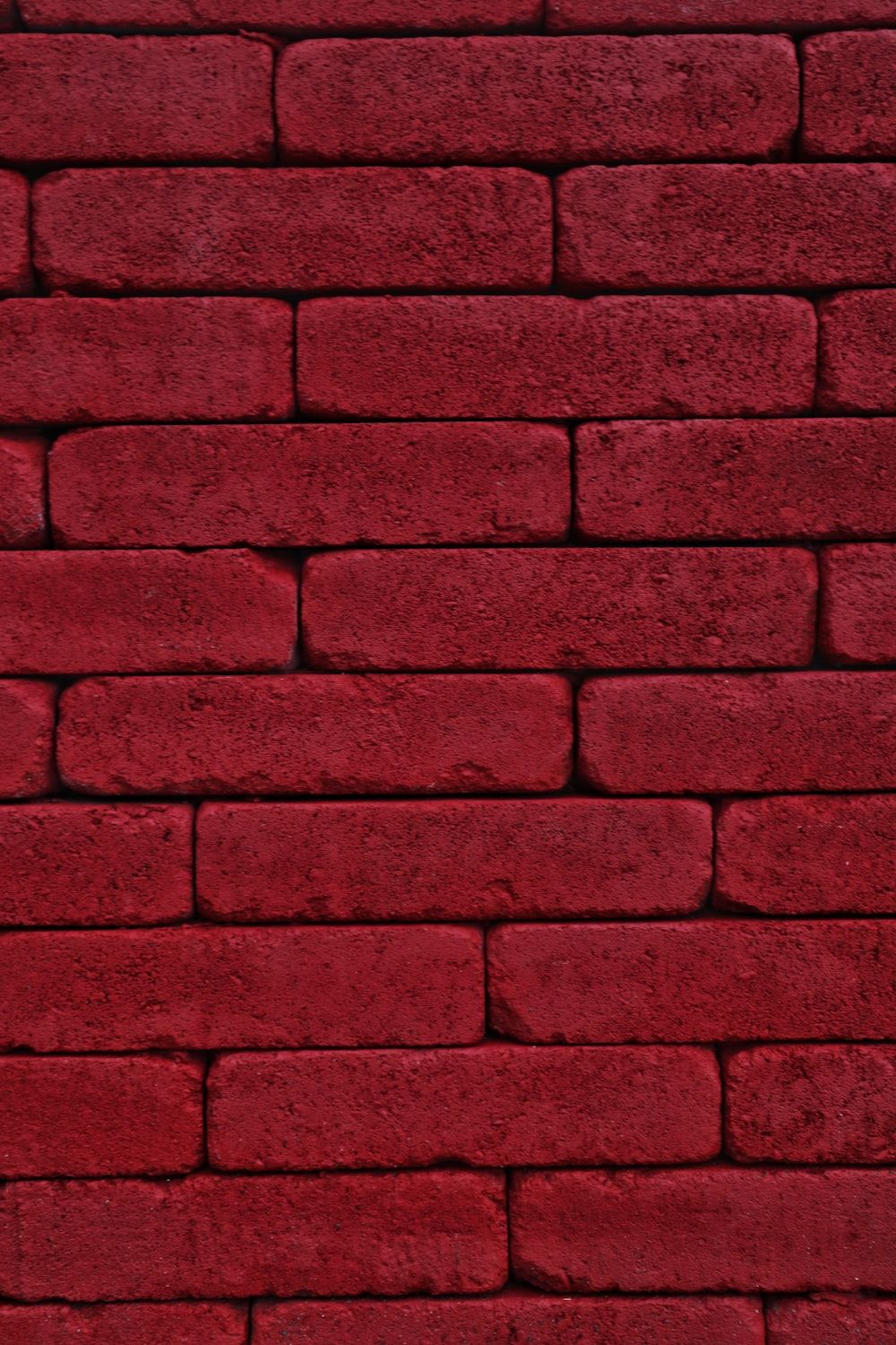 A red brick wall with some white bricks - Crimson