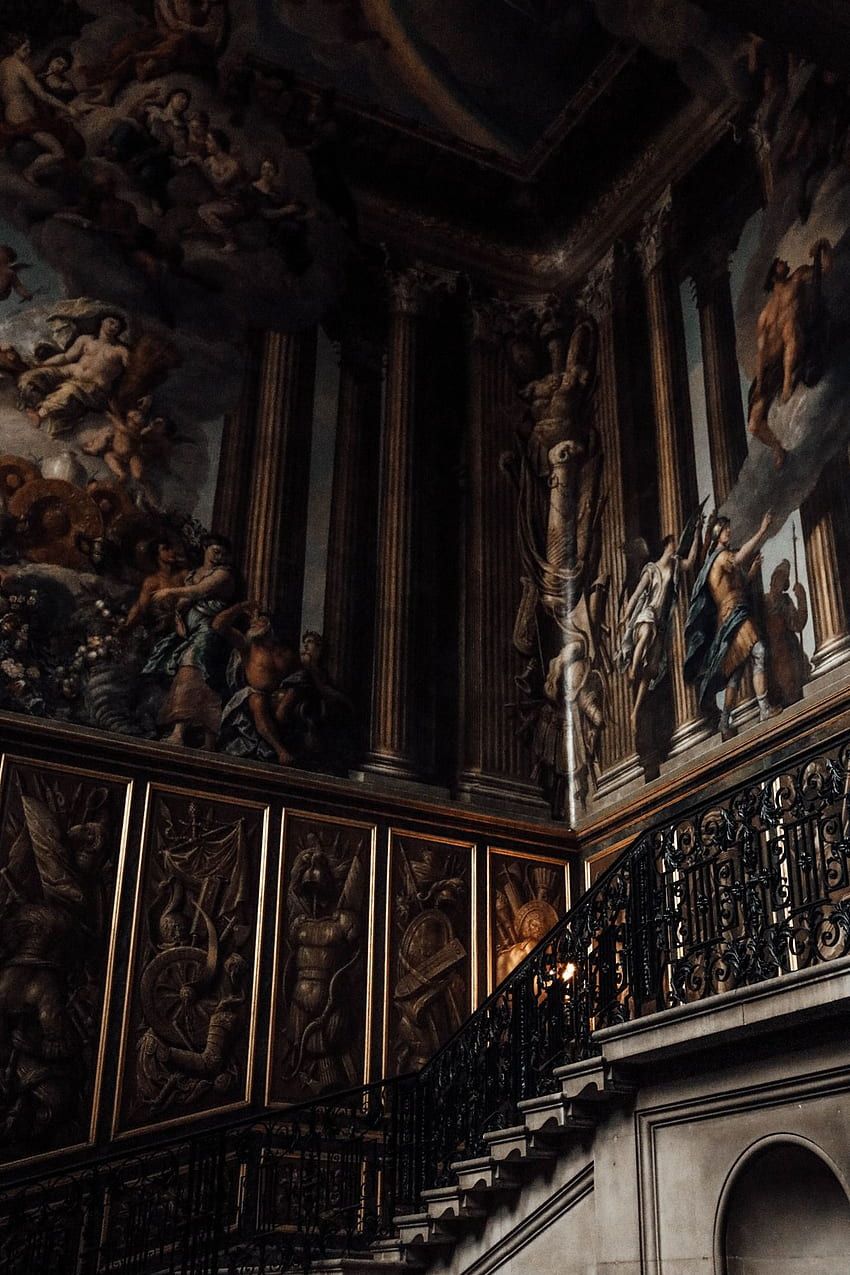 A staircase with a railing and a wall with paintings of angels and other figures. - Castle