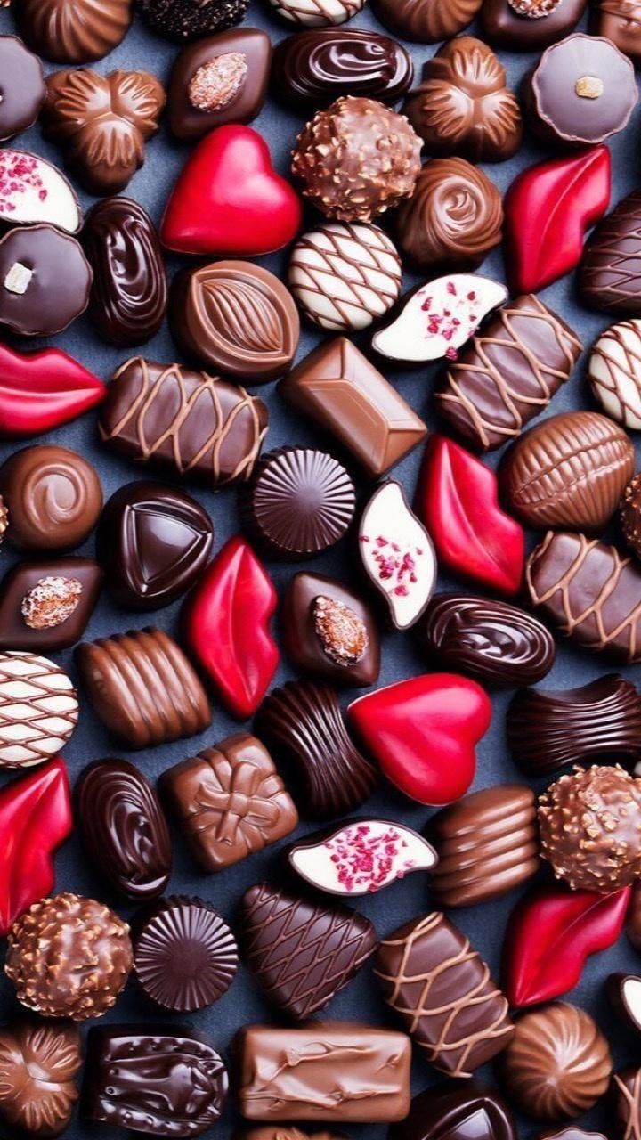 A close up of a variety of chocolate candies. - Candy, chocolate