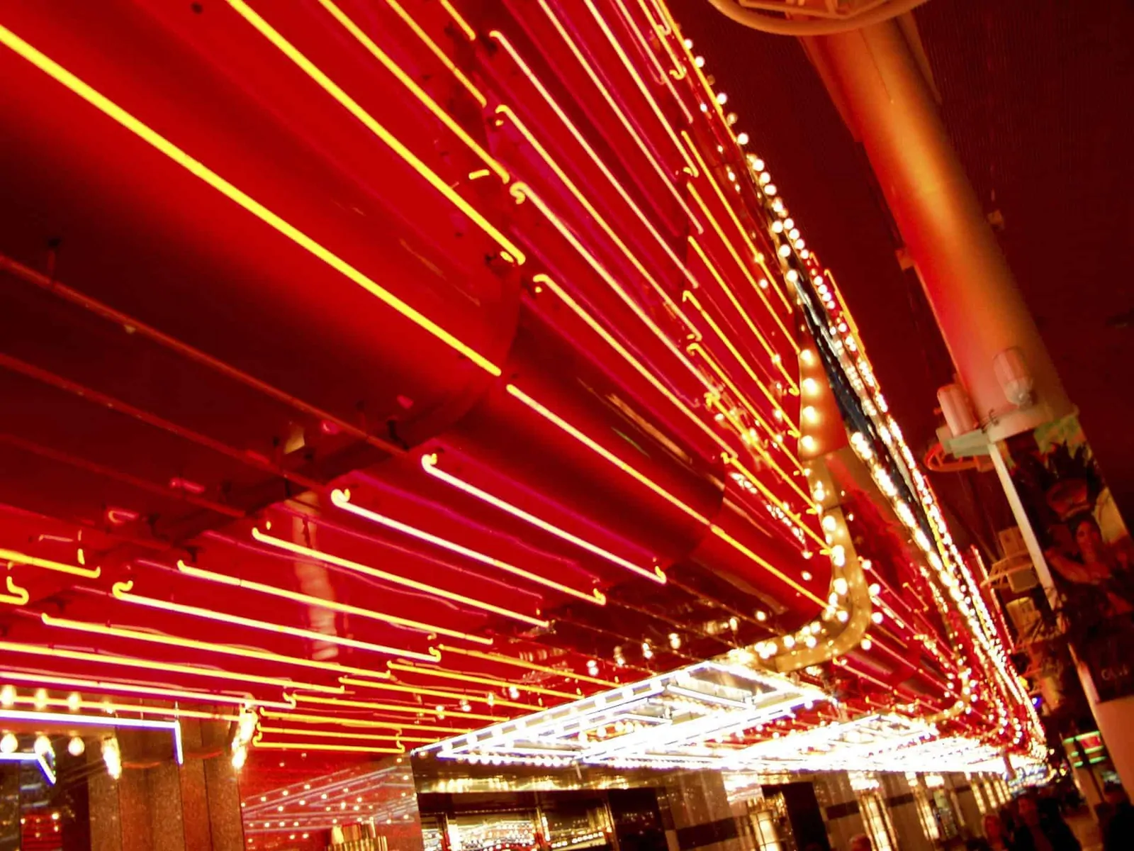 A long row of red and yellow neon lights on a building - Las Vegas