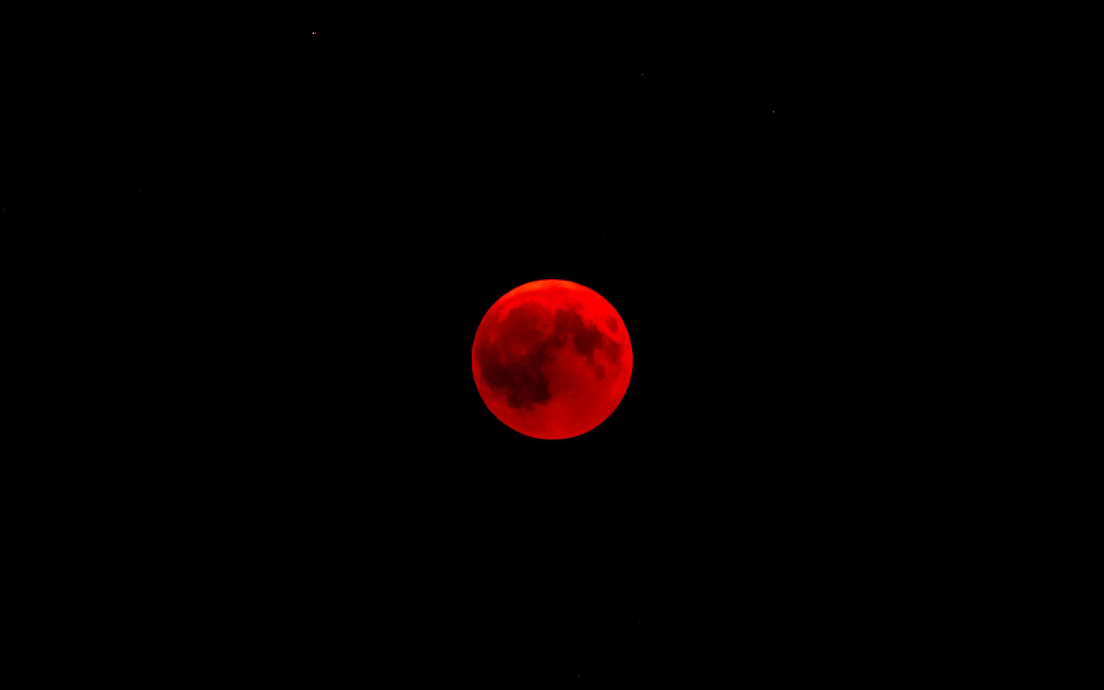 A red full moon is seen in the sky. - Crimson