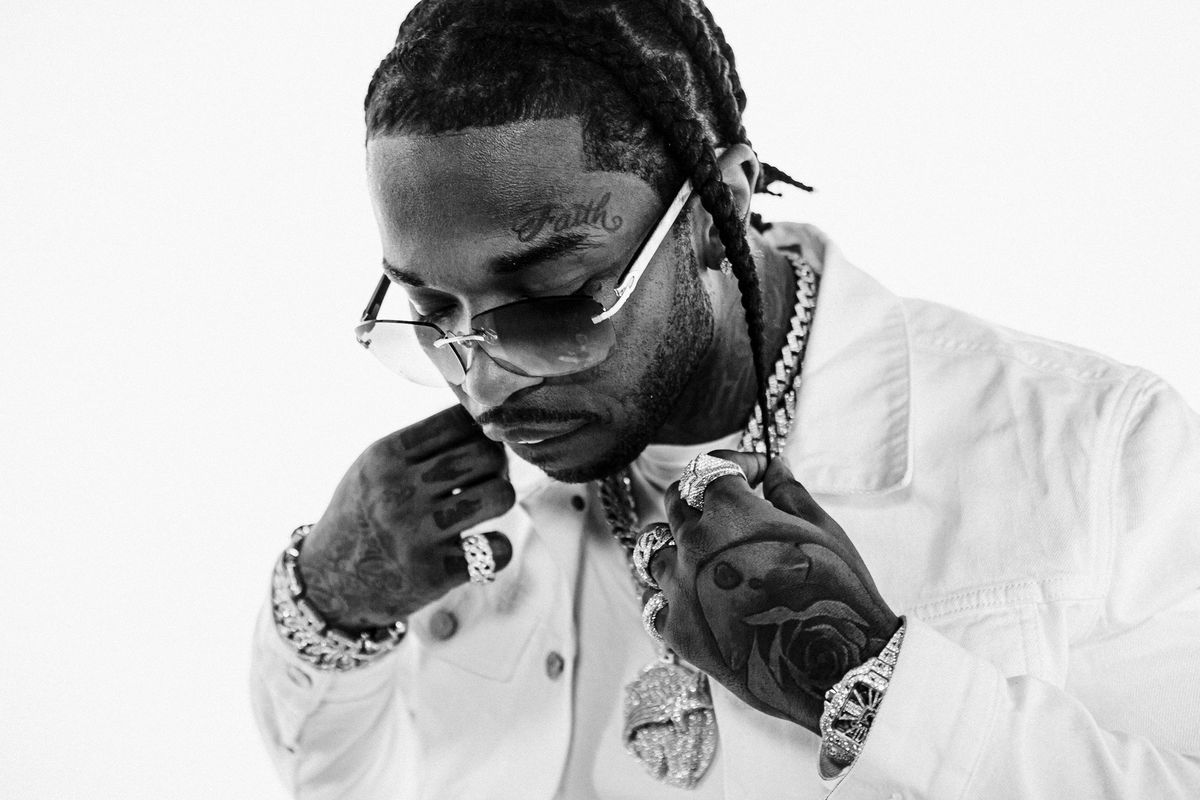 2 Chainz in a white shirt and sunglasses, holding a diamond chain - Pop Smoke