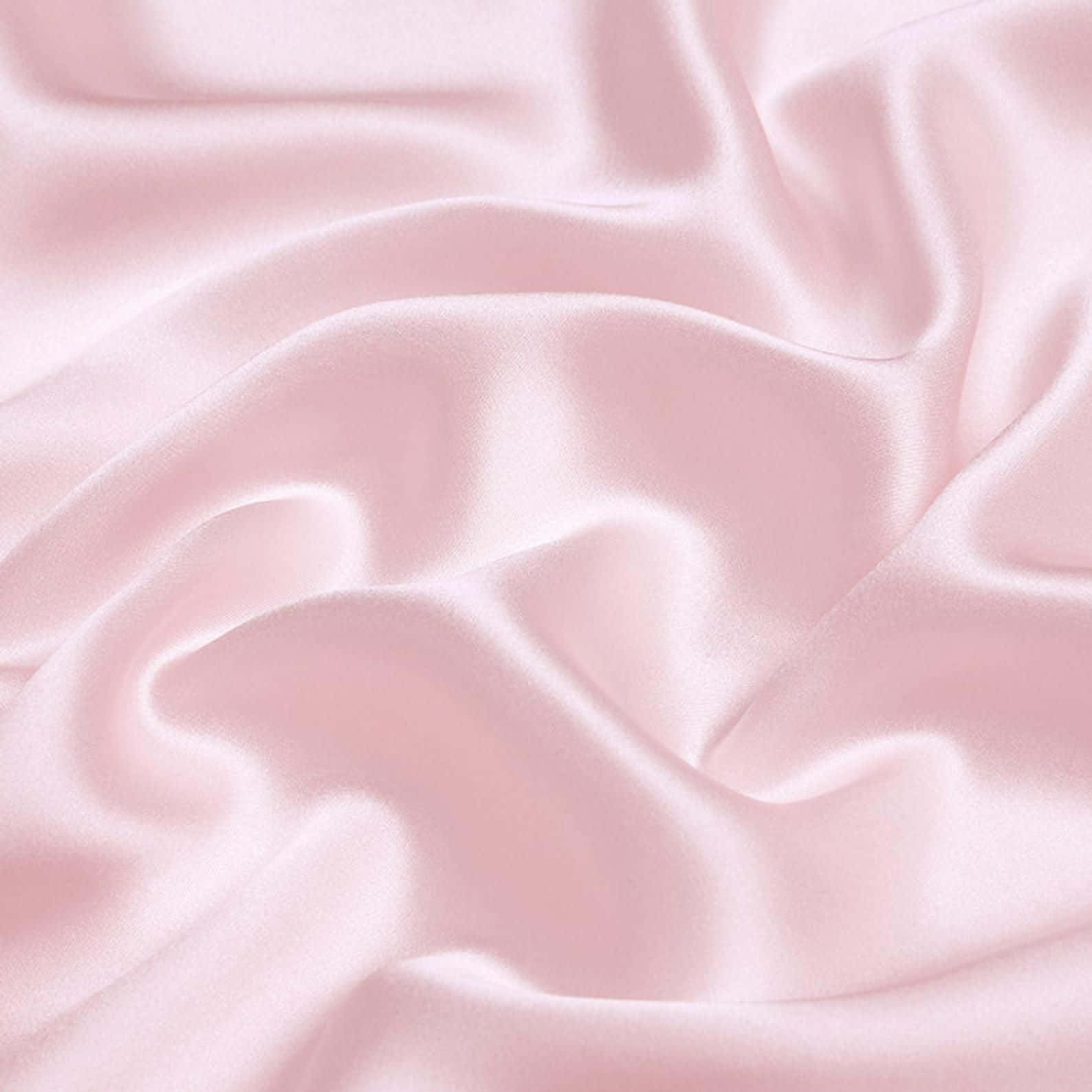 A close up of a pink silk sheet with a lot of wrinkles - Silk