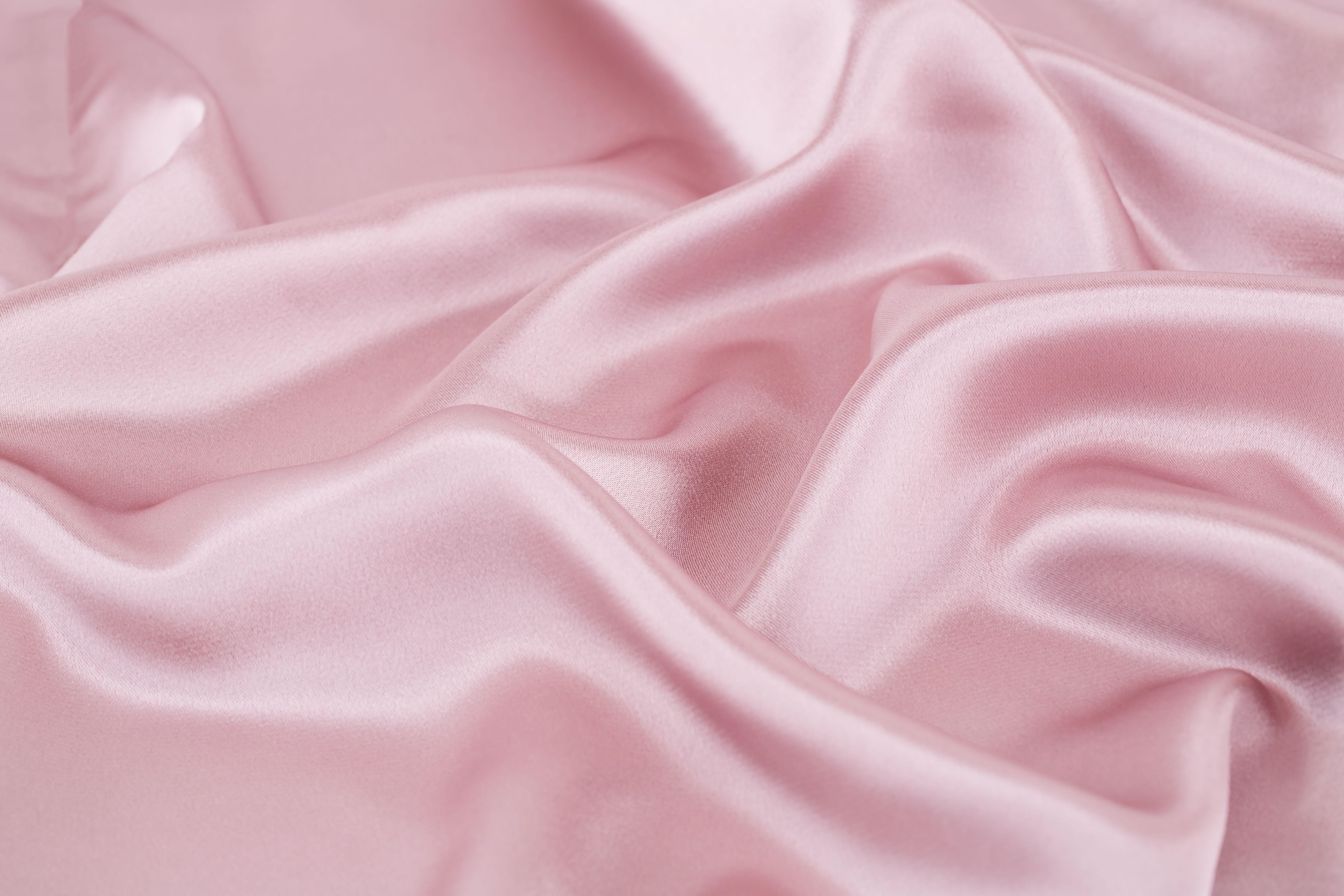 A close up of a pink silk sheet. - Silk