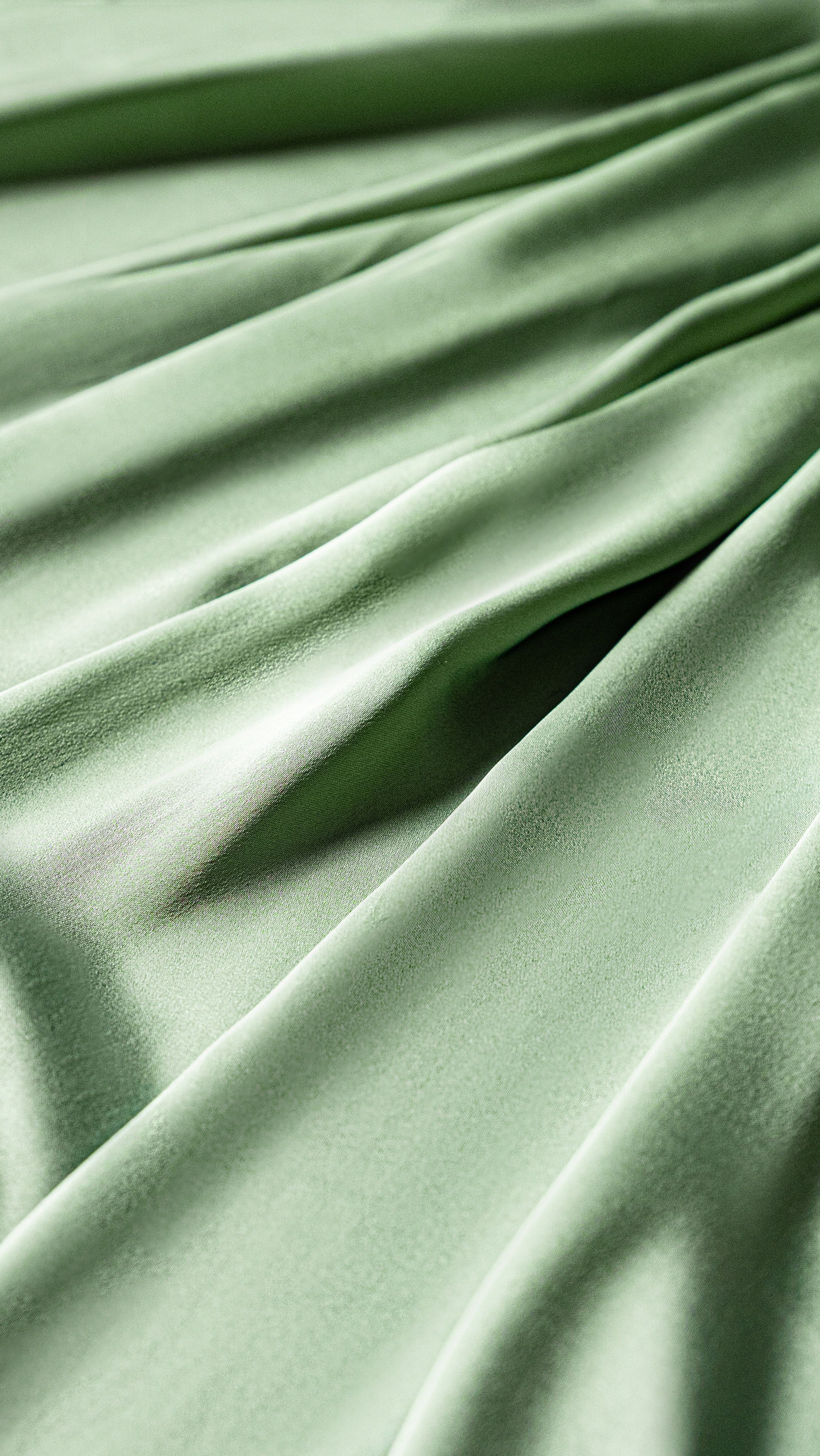 A close up of a green fabric with a crease down the middle. - Silk