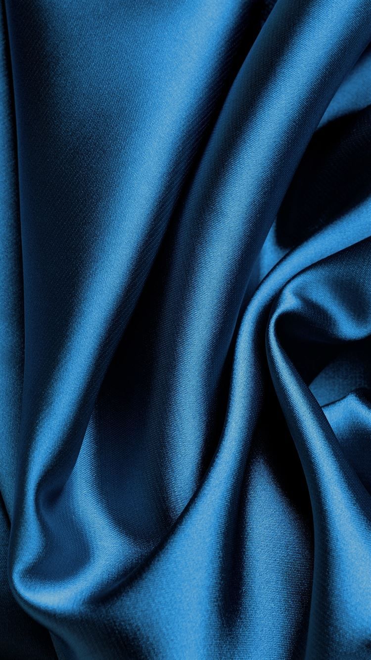 A blue fabric that is being used to make curtains - Silk