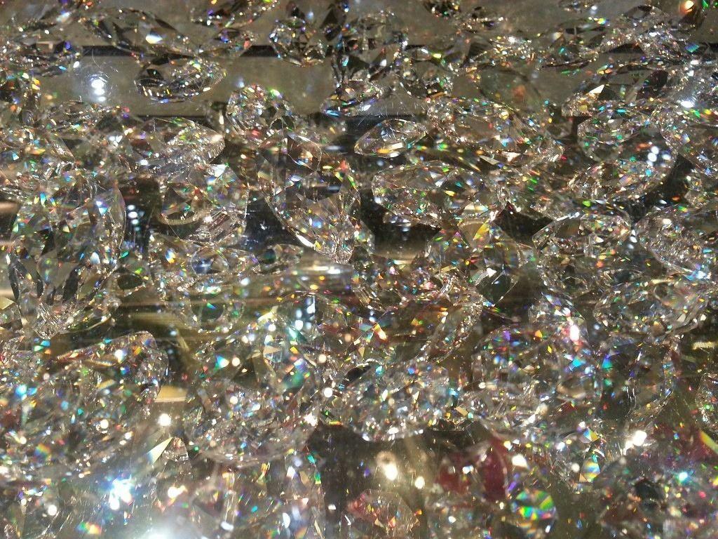 A pile of clear glass crystals with rainbow sheen. - Diamond