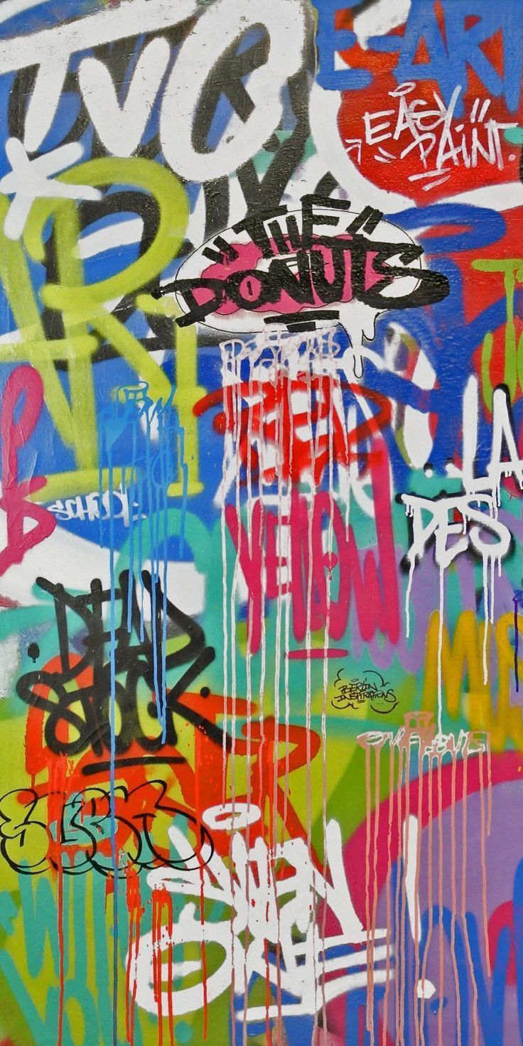 A colorful graffiti on a wall with various colors and fonts. - Graffiti