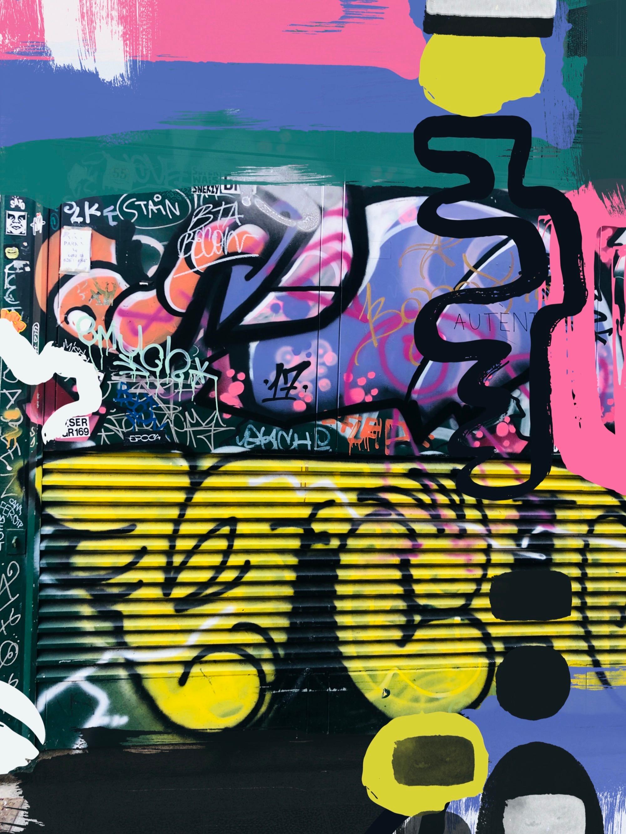 A colorful graffiti wall with a green, pink, and blue background and the word 