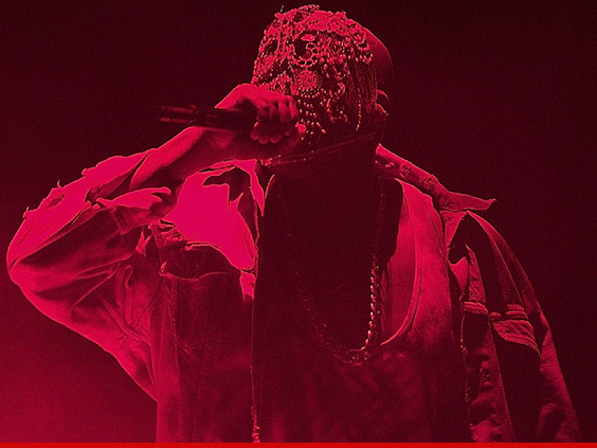 Kanye West wearing a bejeweled mask and a red hoodie - Kanye West