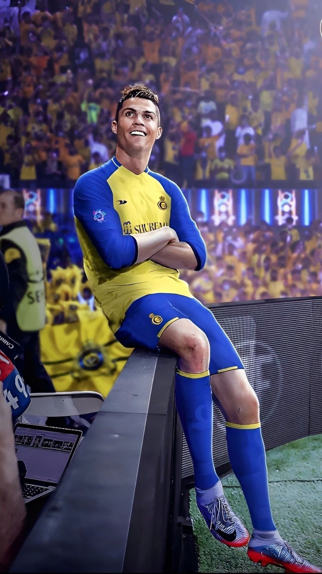 Cristiano Ronaldo in a yellow and blue uniform sitting on a bench - Cristiano Ronaldo