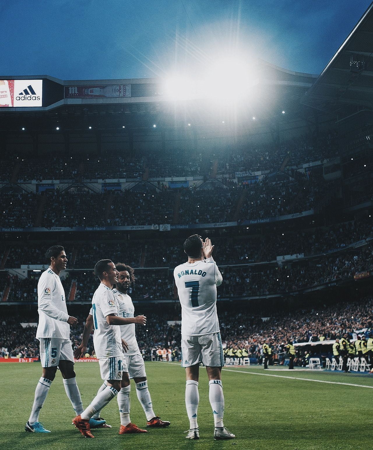 Cristiano Ronaldo and his teammates celebrating a goal in a soccer match. - Cristiano Ronaldo