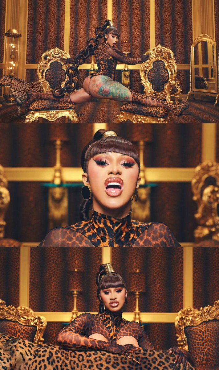 Cardi B is sitting on a throne in a leopard print body suit. - Cardi B