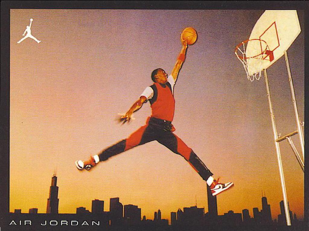 A man jumping in the air with a basketball in his hand. - Air Jordan