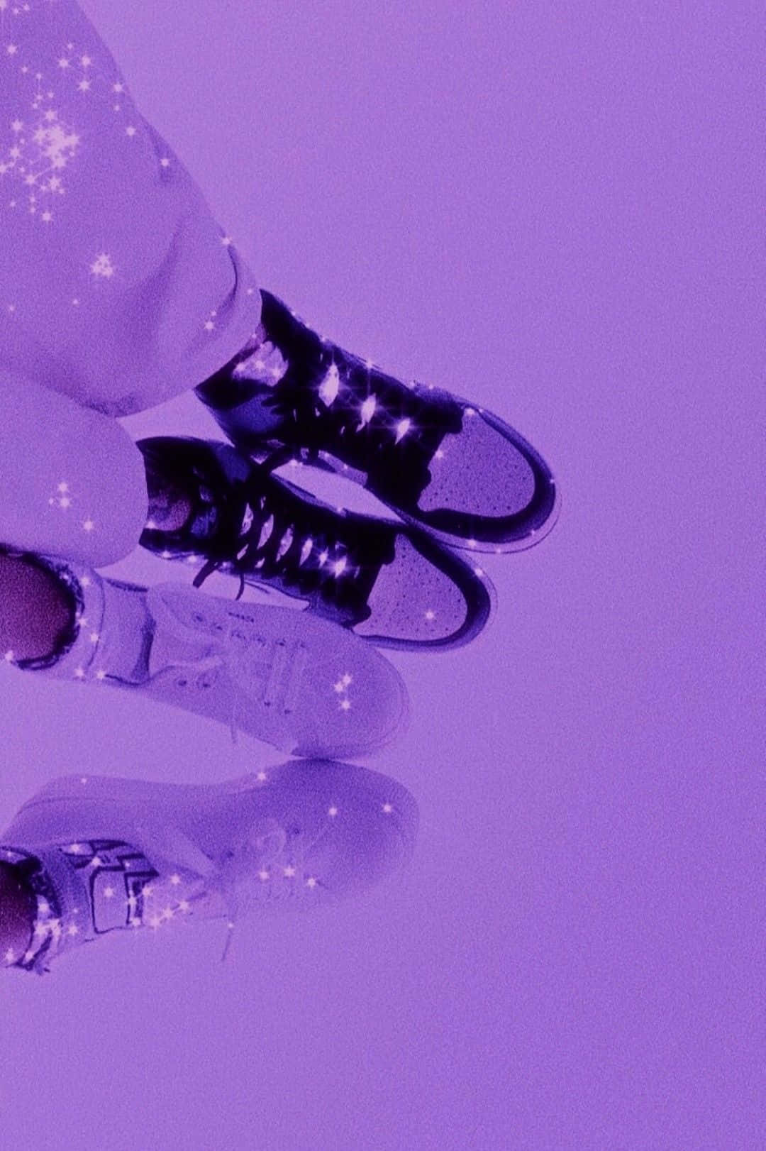 A pair of feet wearing trainers on a purple background - Shoes