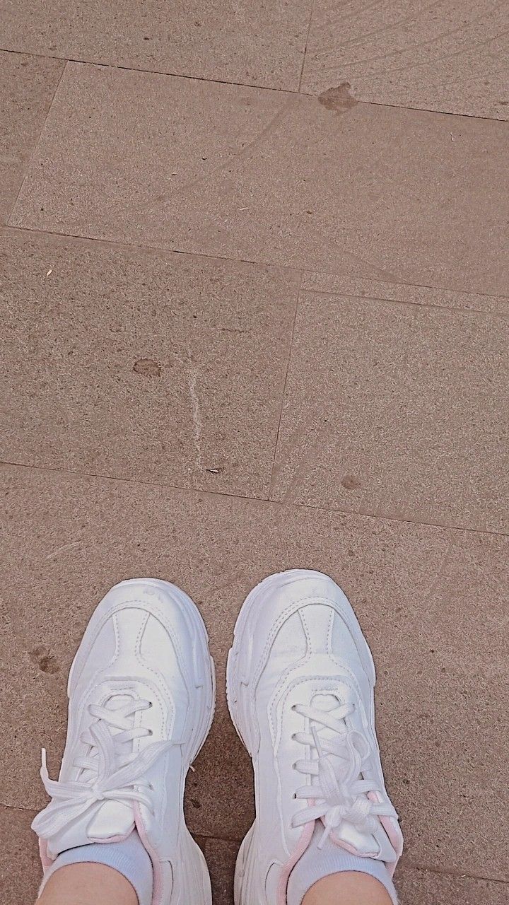 A pair of white shoes on a tile floor - Shoes