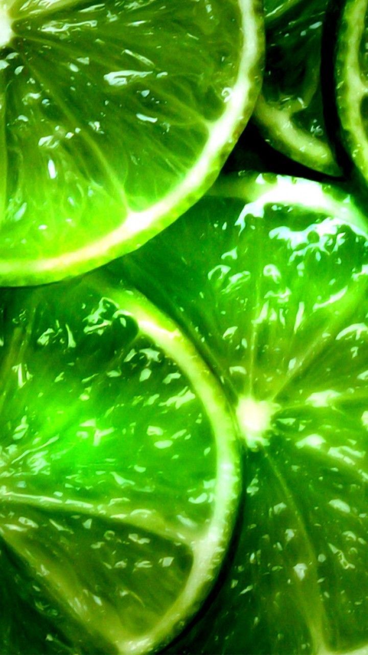 Sliced lime background with a close up view of the slices. - Lime green