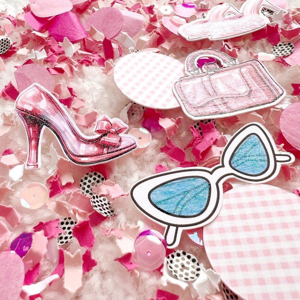 A pile of pink and white confetti with pink high heels, sunglasses, and a purse. - Barbie, makeup