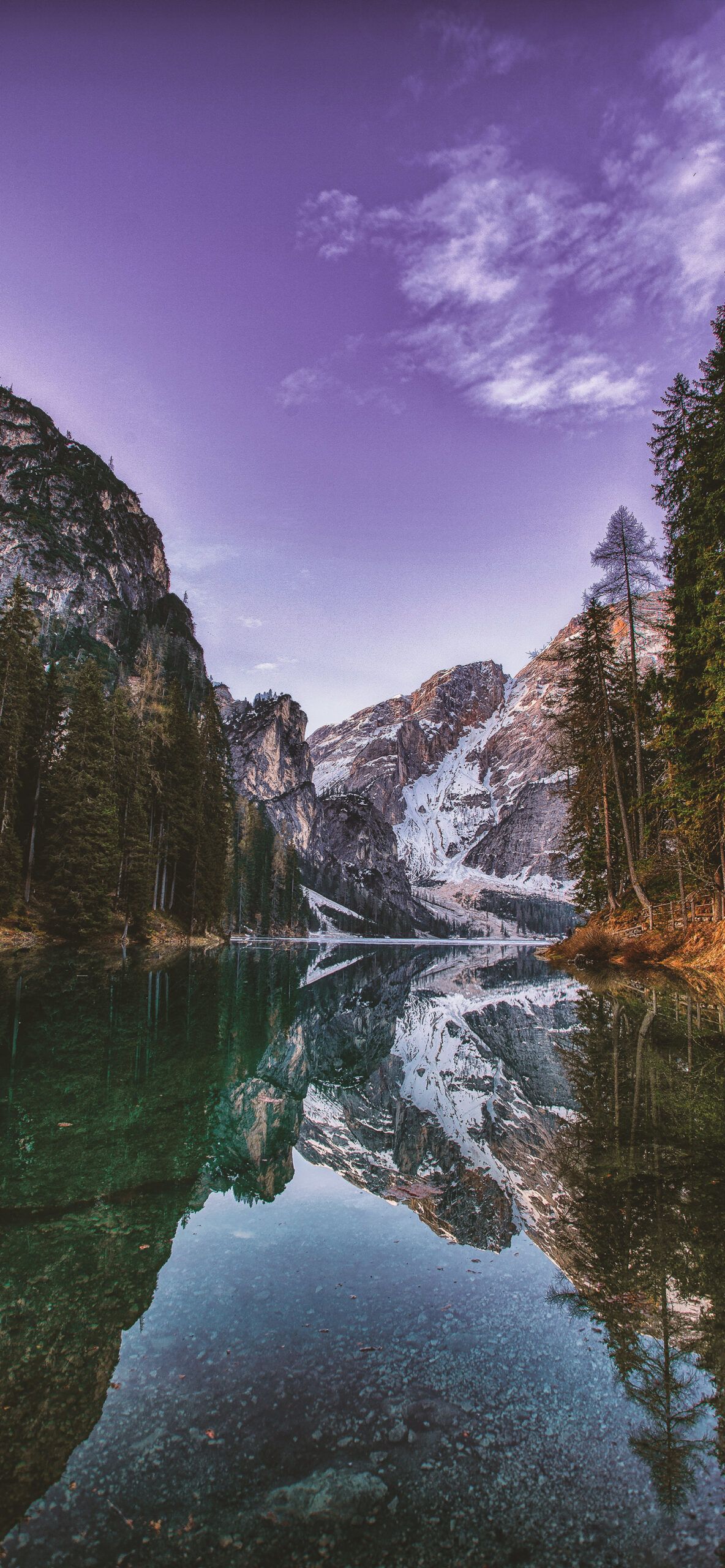 A mountain lake surrounded by trees and snow capped mountains - Mountain