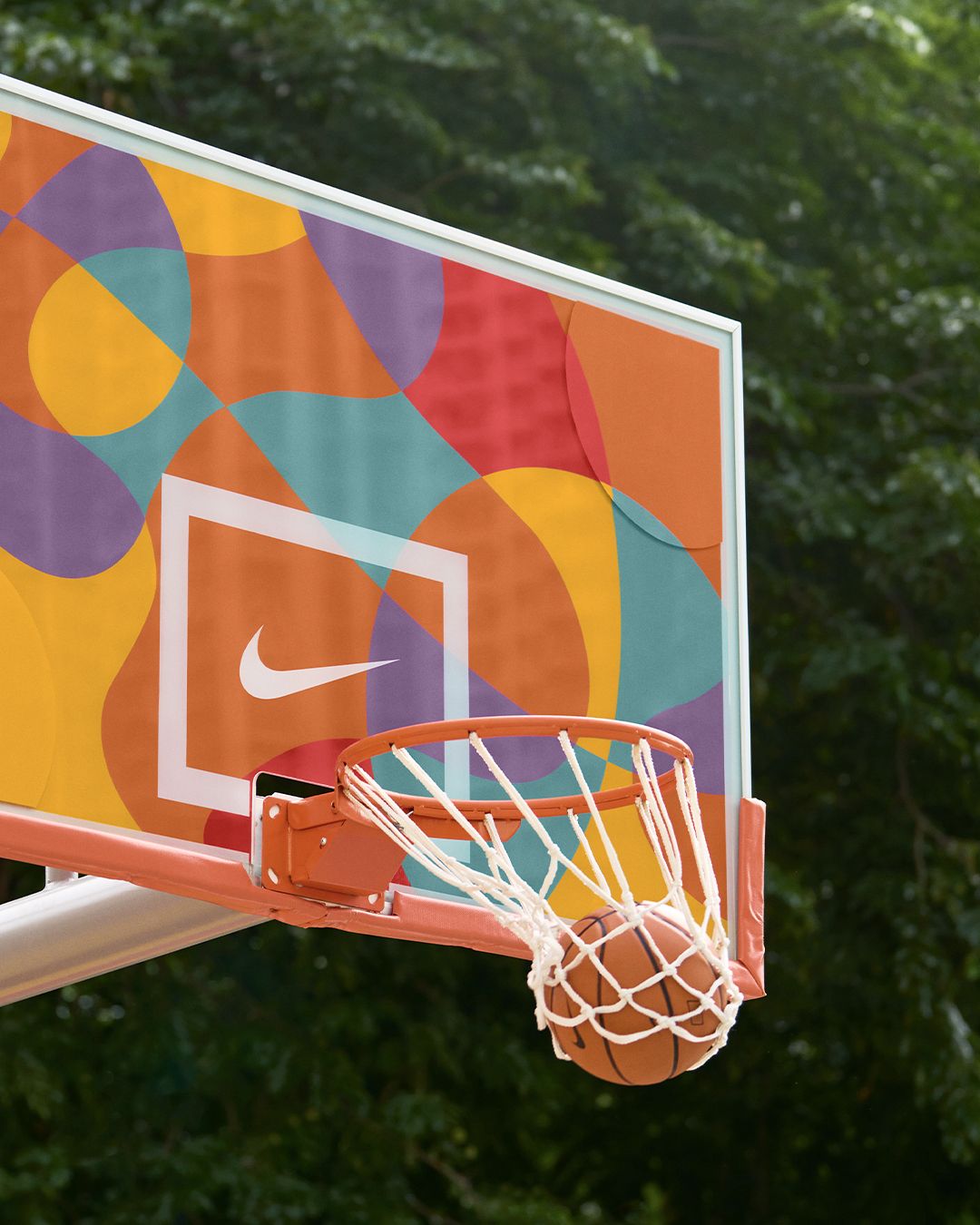 A colorful basketball hoop with a ball in the basket. - Basketball