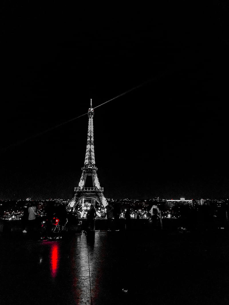 Black and white picture of the Eiffel Tower at night with red lights. - Paris