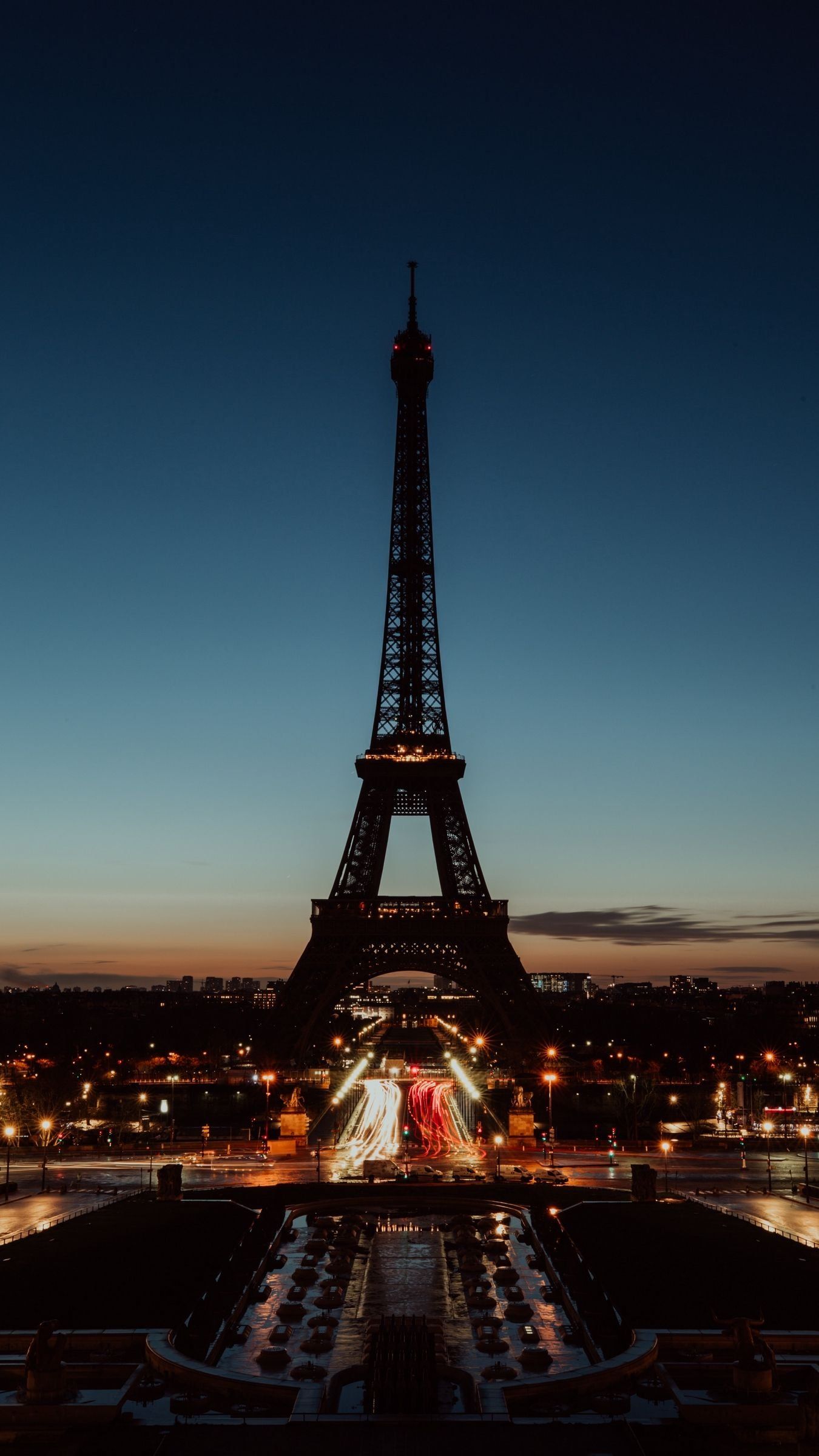 Eiffel Tower at night with city lights in the background - Paris, Eiffel Tower