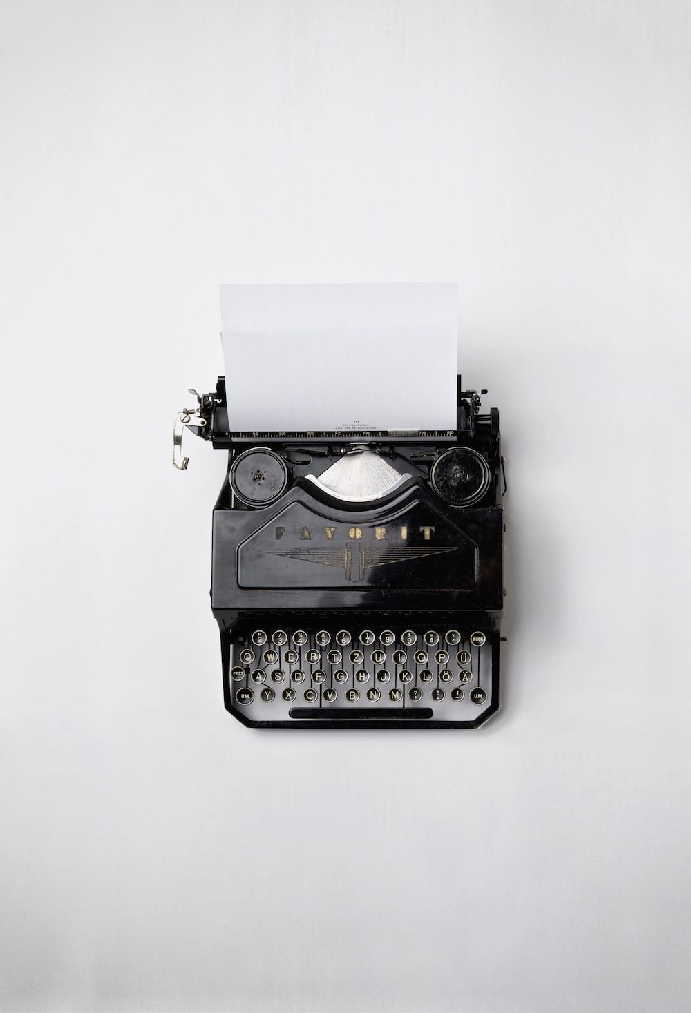 Black and silver typewriter with white paper on top - Gray