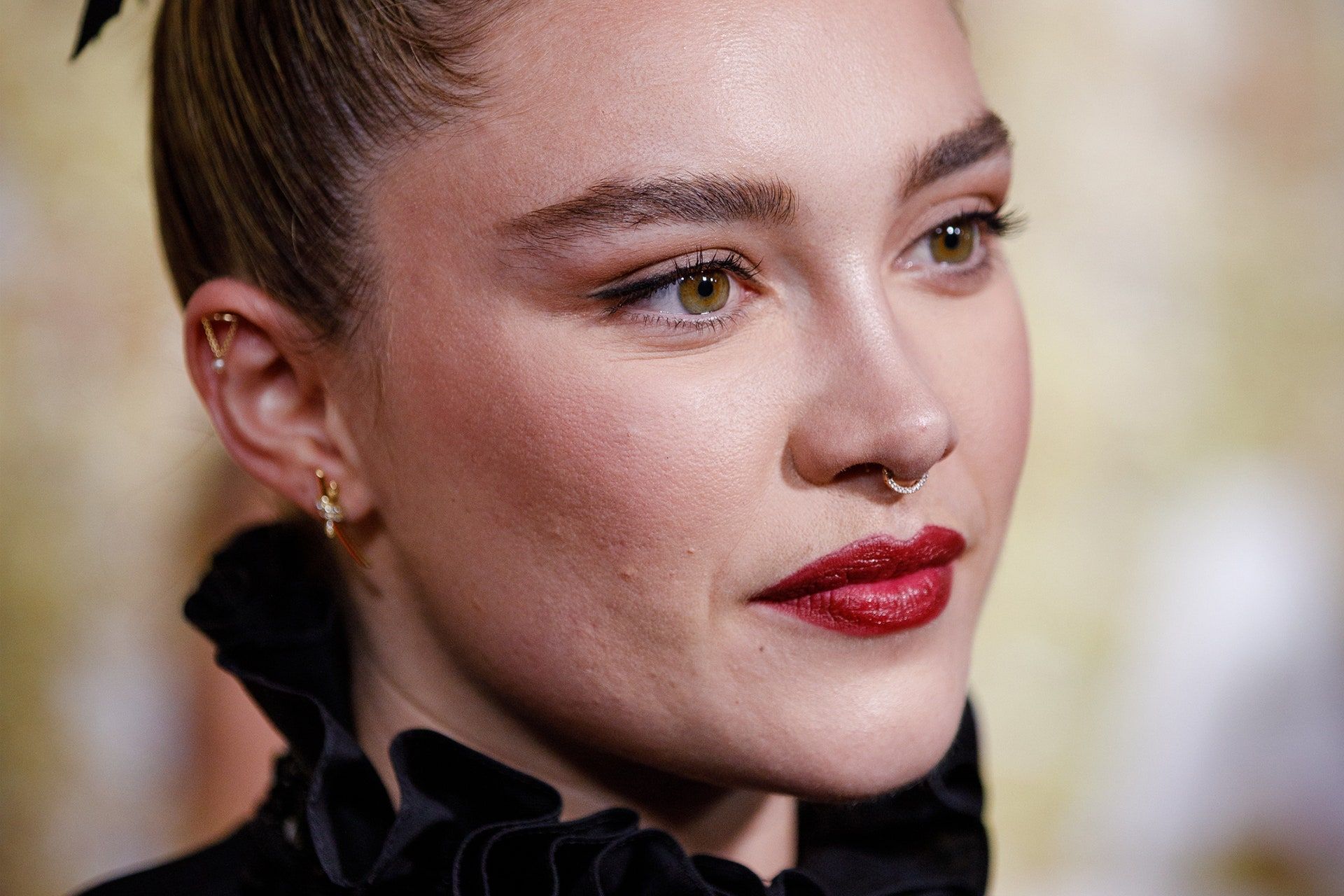 Close up of Florence Pugh with red lipstick and a nose ring - Florence Pugh