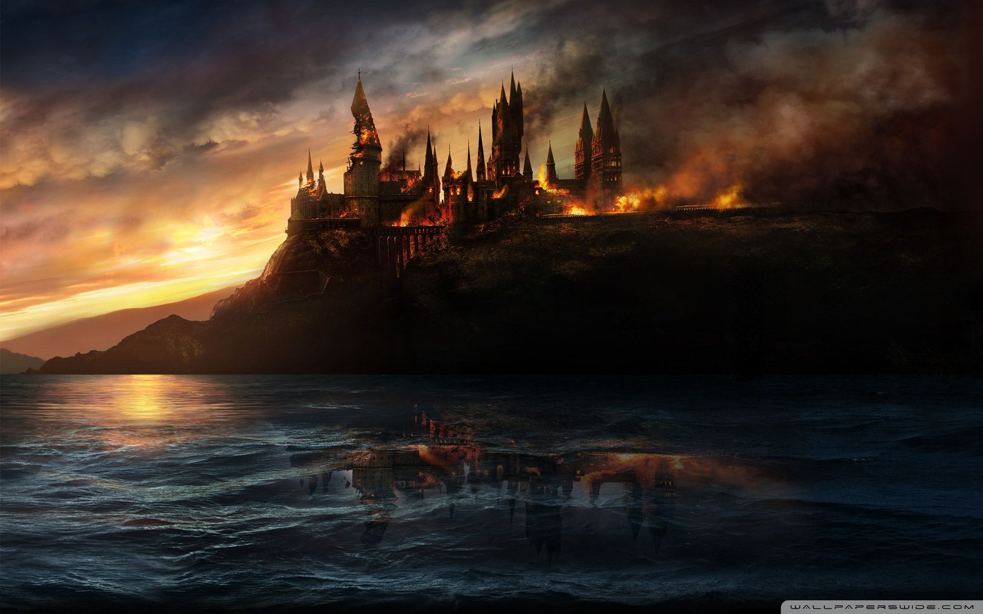 The Hogwarts castle is burning on the hill above the sea - Harry Potter