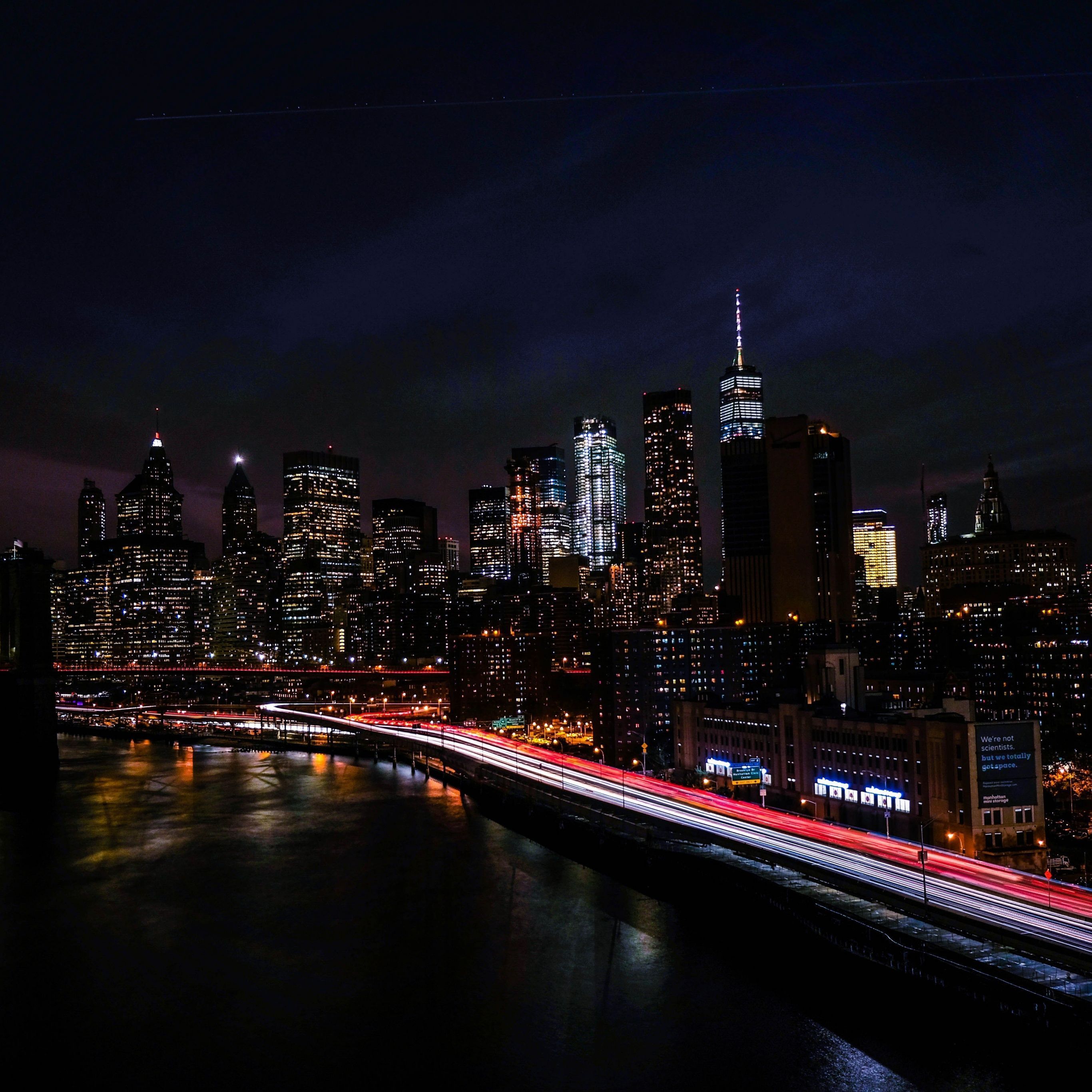 A night shot of the Brooklyn Bridge and the city of New York. - Skyline, New York