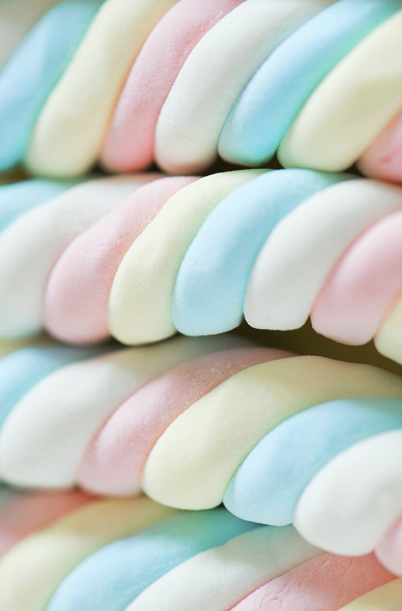 A close up of a pile of rainbow colored marshmallows - Marshmallows