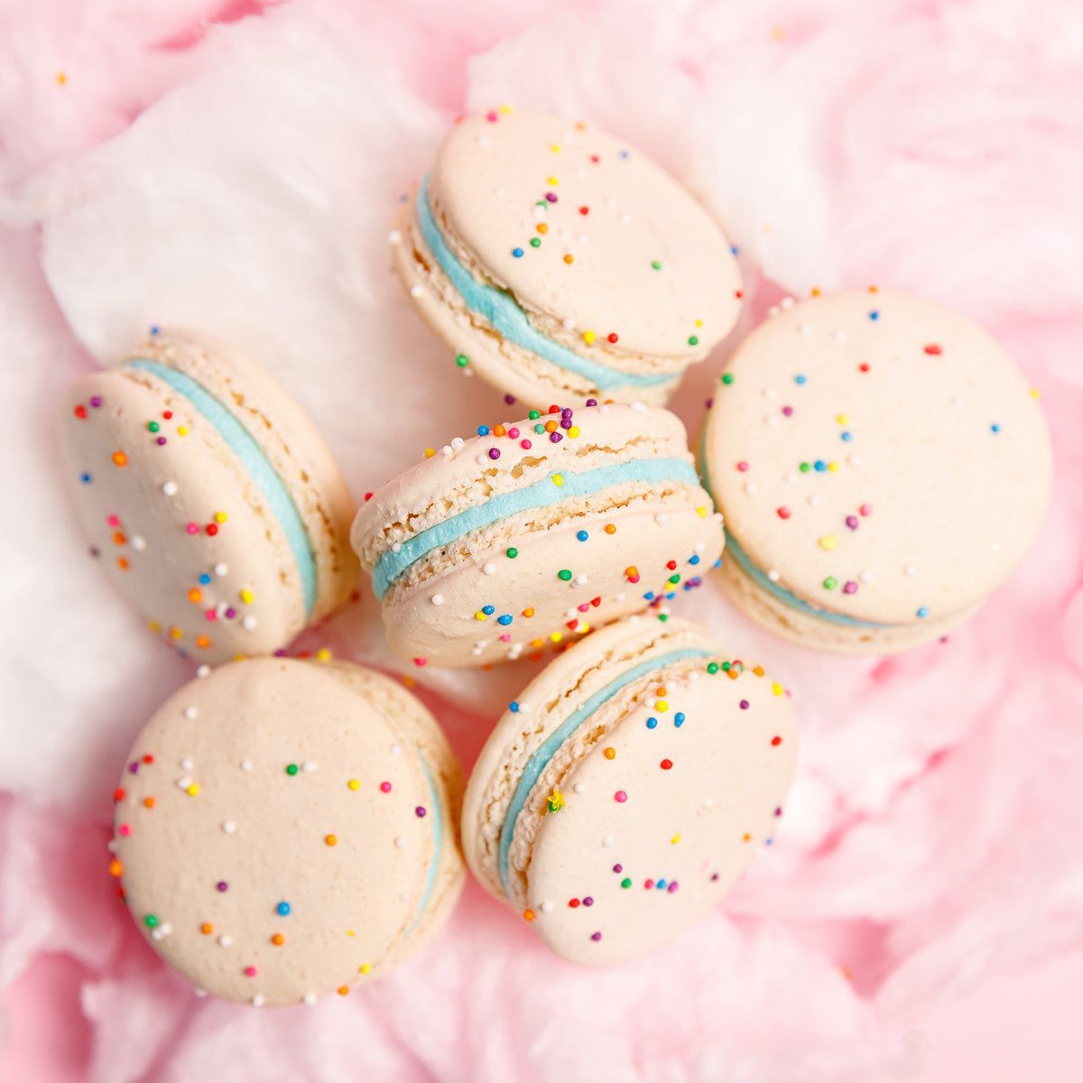 Birthday cake macarons with sprinkles on a pink background - Macarons