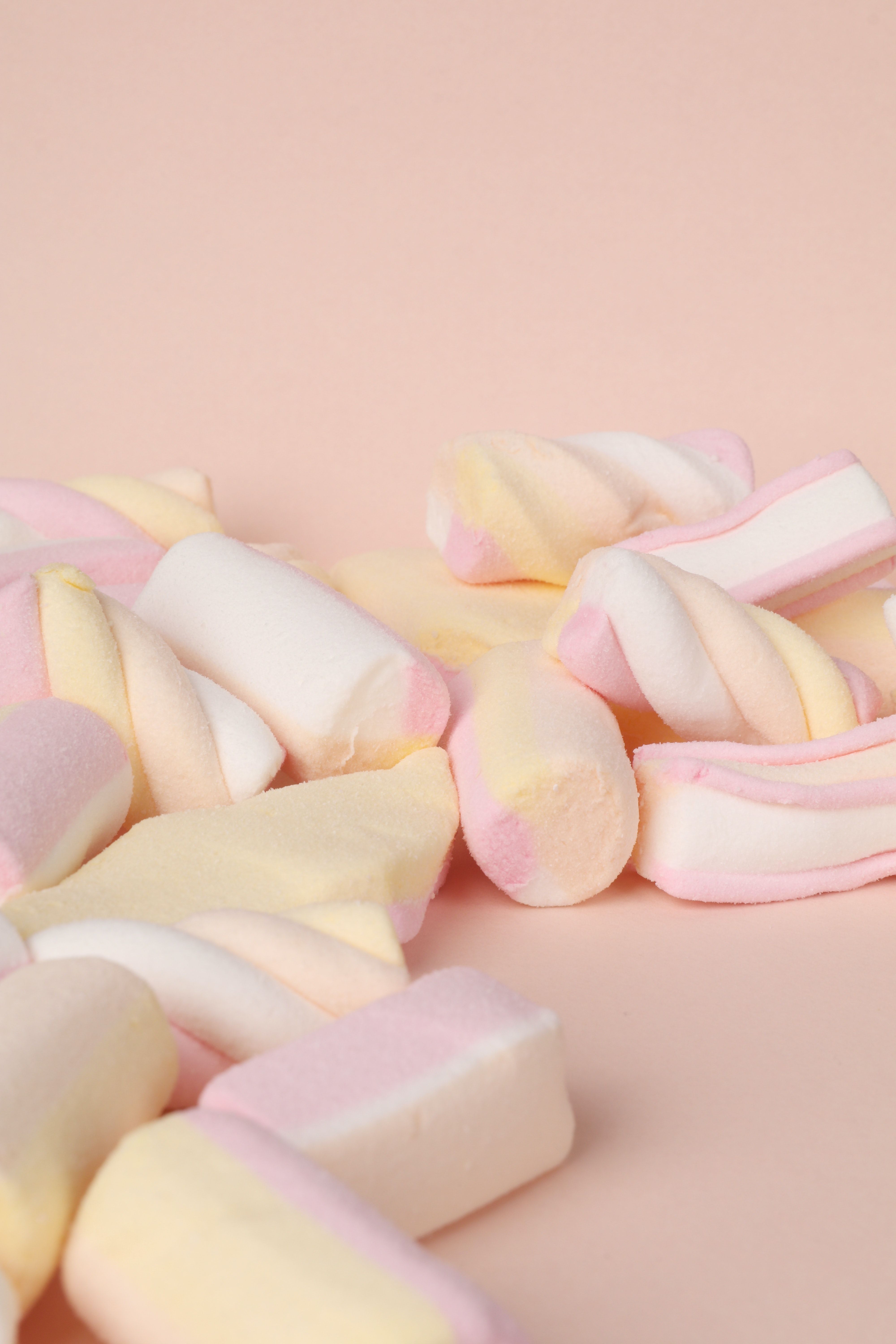 Soft pastel colored marshmallows on a pink background - Marshmallows