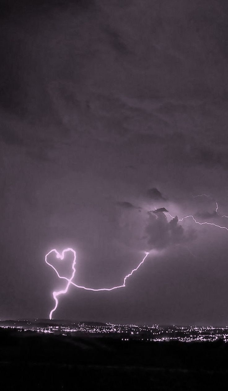 A lightning bolt in the sky over an urban area - Heart, black heart