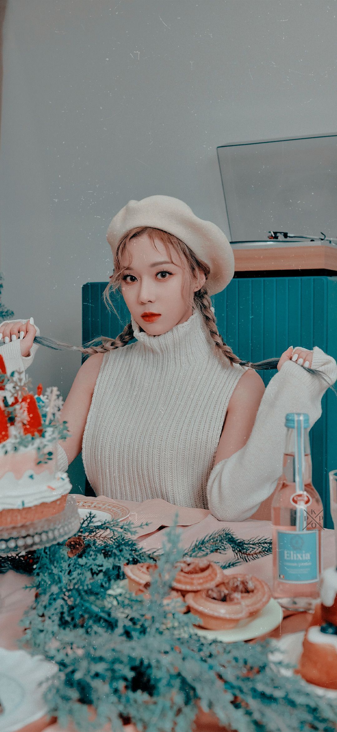 A female with white beret sitting in front of a cake - Aespa