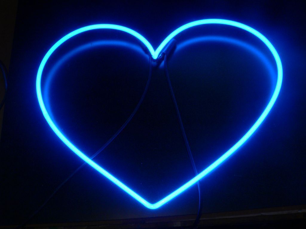 A blue neon heart on a black background. - Dark blue