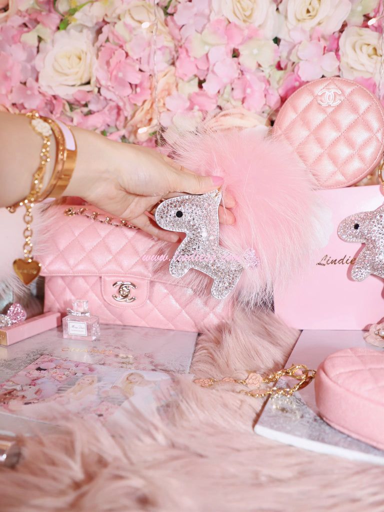 A Chanel bag in pink with a pink fluffy unicorn horn and a pink fluffy purse. - Bling