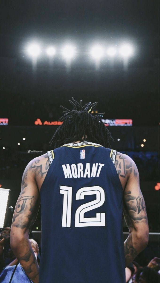 A basketball player with tattoos on his arms - Ja Morant