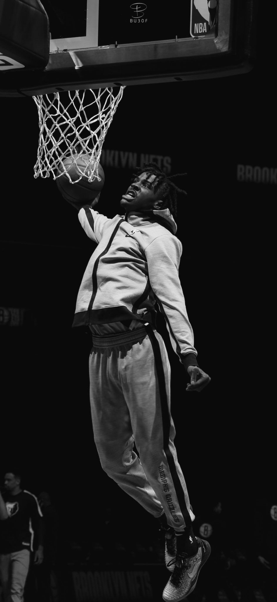 Grayscale photography of a man jumping while hitting the hoop - Ja Morant