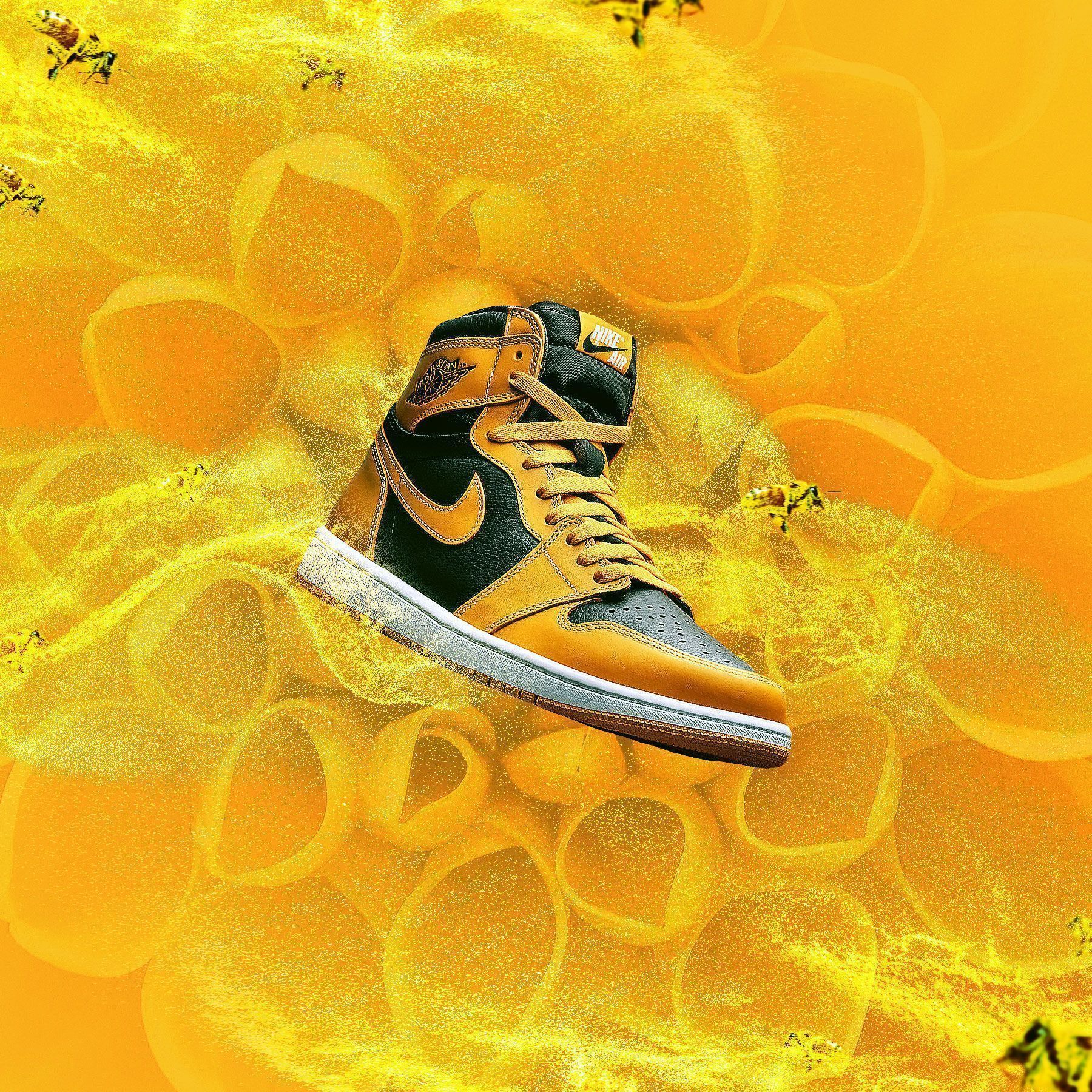 A yellow and black shoe is on top of some flowers - Air Jordan 1